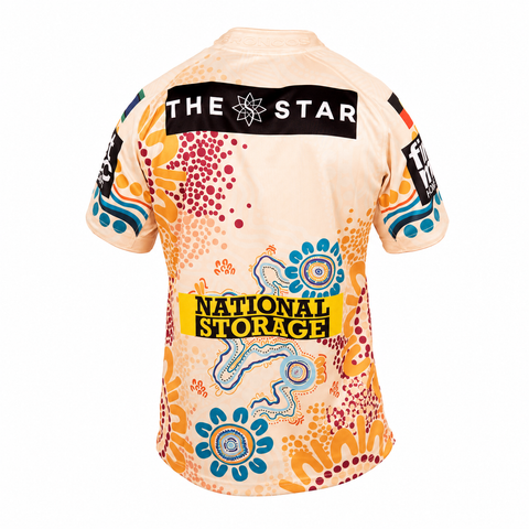 The back of a short-sleeve cycling jersey featuring a cream base with a vibrant orange, blue, and red Aboriginal-inspired dot art pattern. Prominent sponsor logos include 'THE STAR' across the upper back and 'NATIONAL STORAGE' on a yellow block near the lower back.