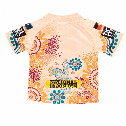 A short-sleeve t-shirt with a retro floral and dot art pattern in orange, blue, and red on a light peach background. The front features a yellow 'National Storage' logo patch on the chest, and stylized 'IT' graphics on the sleeves.