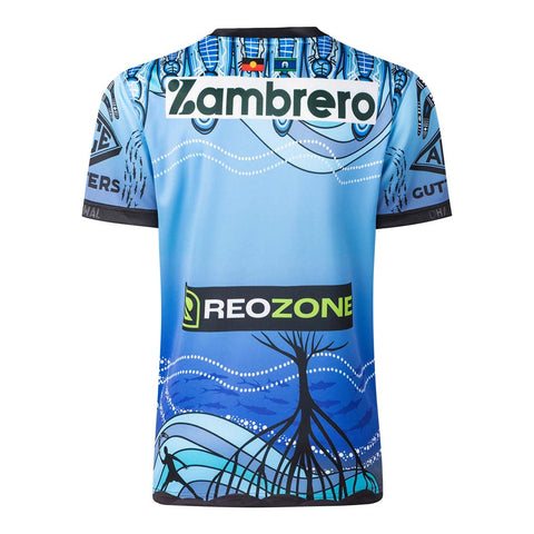 A light blue and dark blue soccer jersey with a graphic design featuring a tree and wavy lines, featuring sponsor logos 'Zambrero' and 'REOZONE'.