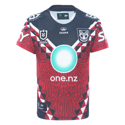 A short-sleeve New Zealand Warriors Indigenous jersey with a red, navy, and white geometric and tribal pattern. It features a large glowing cyan circle on the chest, the 'one.