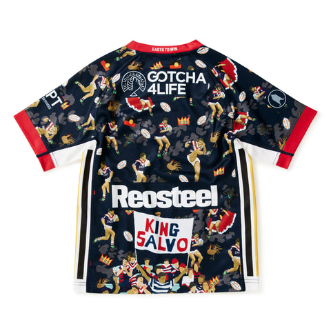A dark navy blue short-sleeve jersey with a busy all-over graphic print featuring cartoon figures, footballs, and bold sponsor logos including Reosteel, King Salvo, and Gotcha 4 Life. The jersey has red and white trim on the collar, cuffs, and sides, and is displayed flat against a white background.
